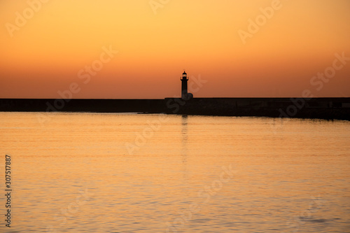 Lighthouse at sunset in Douro River estuary  Porto  Portugal. Golden hour