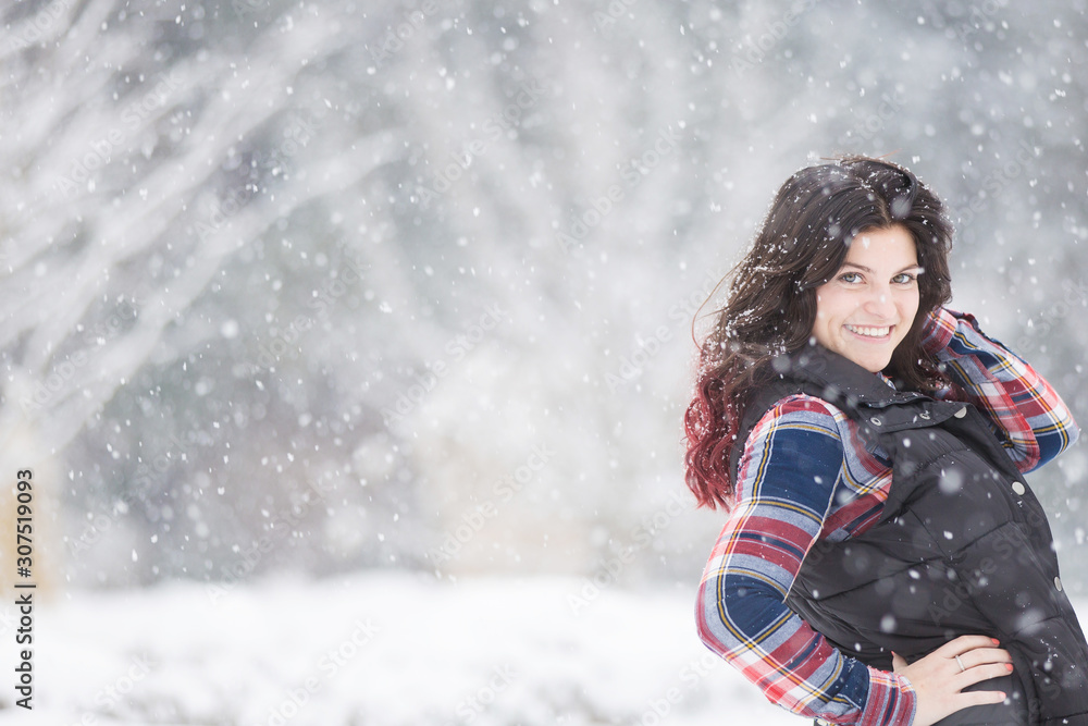 Beautiful young woman in snowfall Beautiful young woman in snowfall