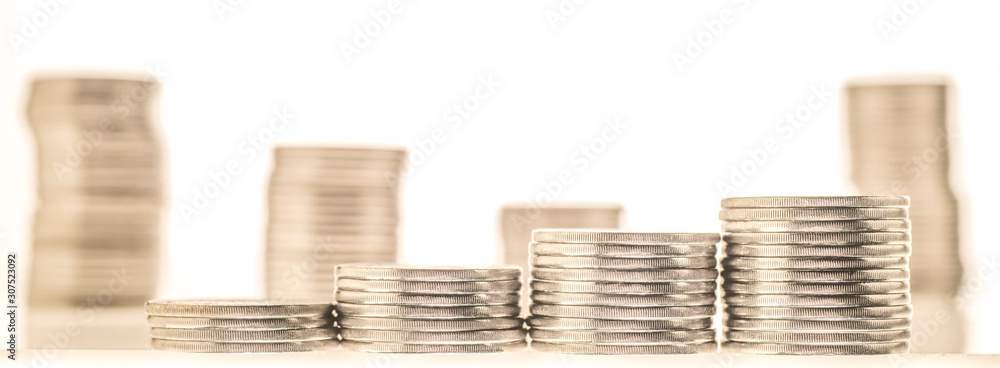 columns of coins close-up on a white and colored backgrounds
