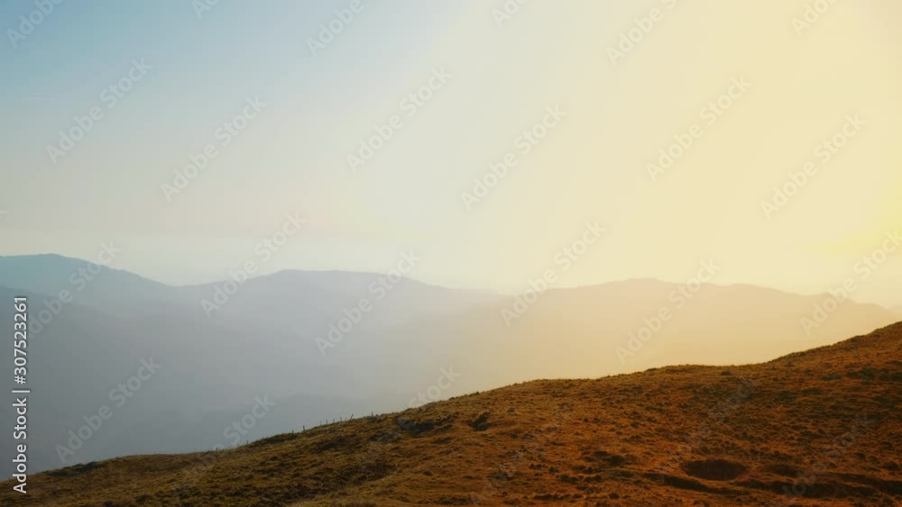 Aerial shot of two runners holding their hands in the air, admiring the view Aerial shot of two runners holding their hands in the air, admiring the view