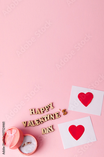 Wedding ring and many hearts with an inscription Happy Valentine's Day on a pink background..Festive concept for Valentine's day, Mother's day or birthday