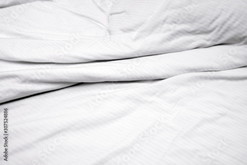 White delicate soft background of fabric or bedding sheet © pookpiik