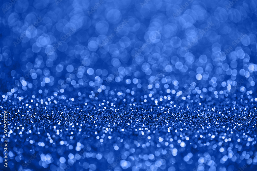 color of the year 2020, classic blue, shinig sparkles bokeh background. color of the year 2020, classic blue, shinig sparkles bokeh background.