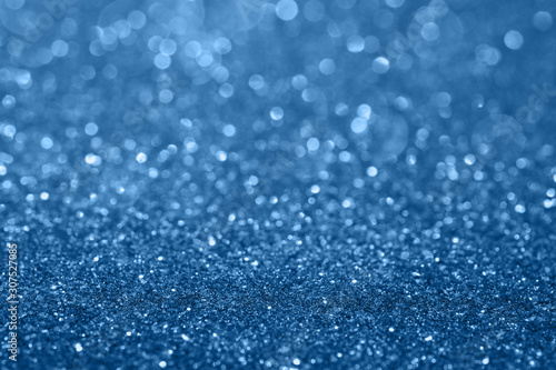 Abstract composition. Classic blue glitter light background with beautiful bokeh. Color of the year 2020