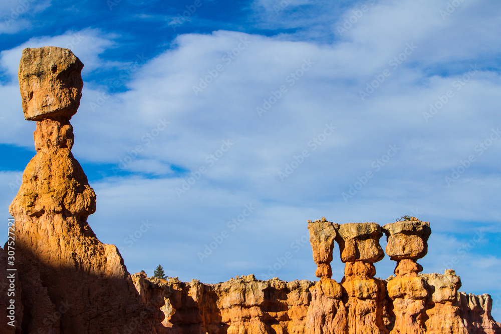 Four hoodoos lit by the afternoon sun in Bryce Canyon National Park.