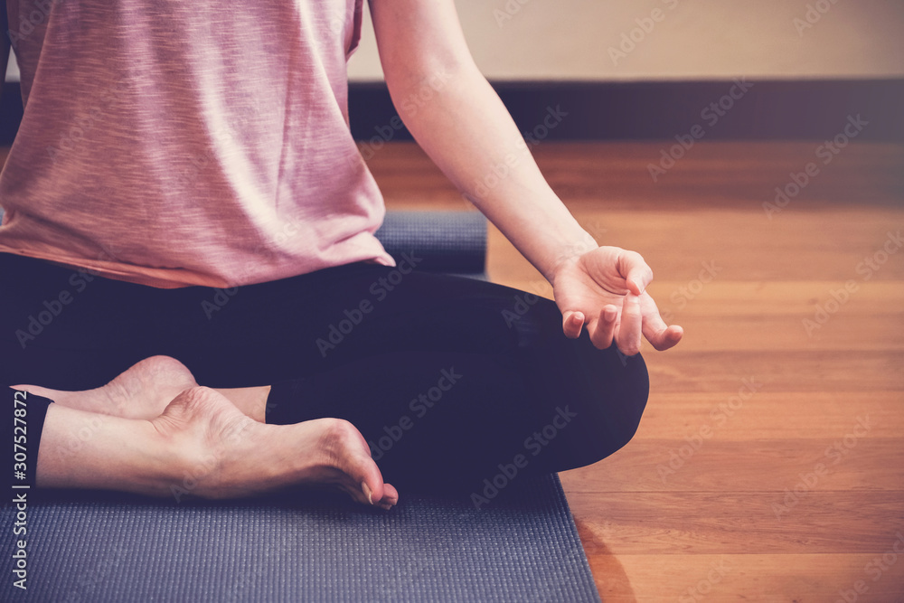 young healthy woman practicing yoga lesson, lotus pose with instructor in home studio, wellness and fitness lifestyle concept, new year 2020 healthy resolution, home  exercise, social distance concept