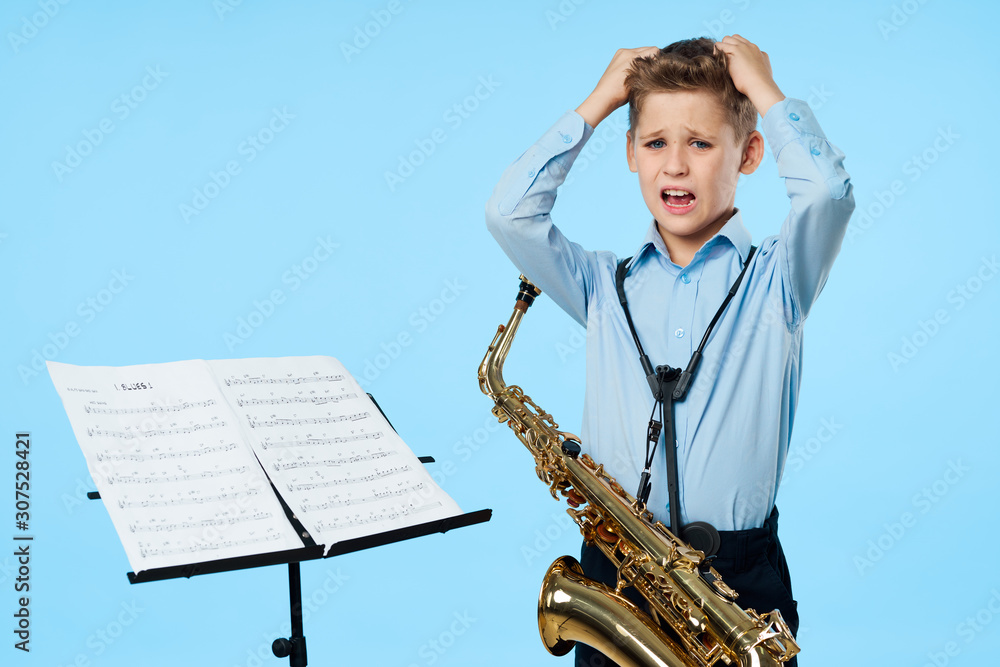 Naklejka premium boy with saxophone