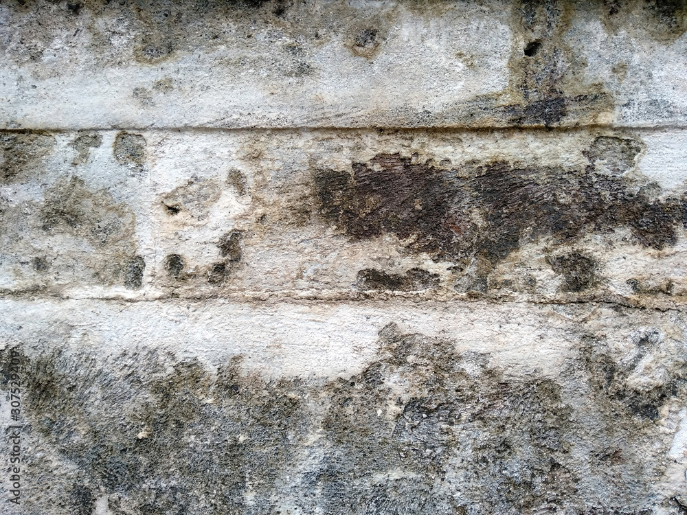 Obraz premium Abstract texture of mossy, porous, cracked and weathered sandstone walls. Wall texture can be used as a wall frame and wall background. Dirty and Old sandstone wall texture background.