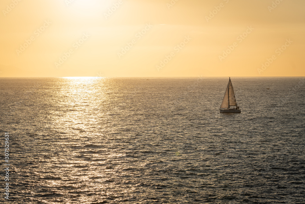 Sailboat sailing into the sunset