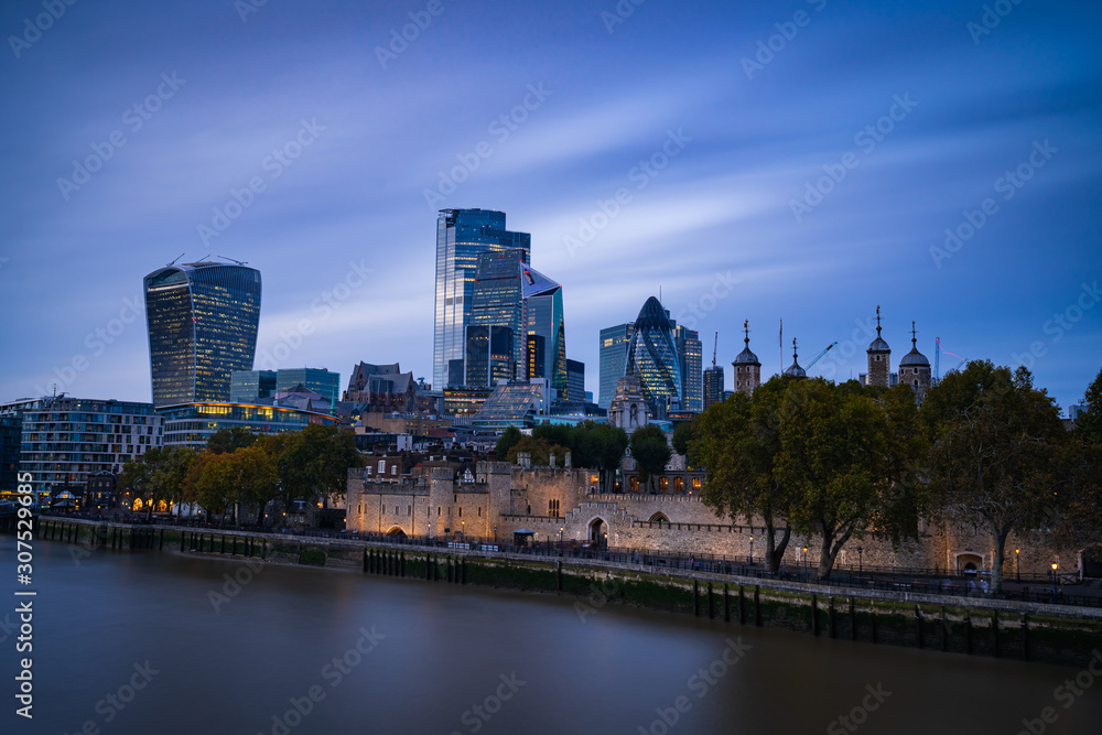 The City of London at nightfall with the Tower and Thames in the foreground