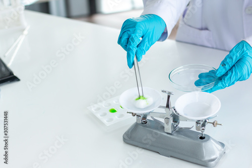 Researchers are weighing tablets in the laboratory.