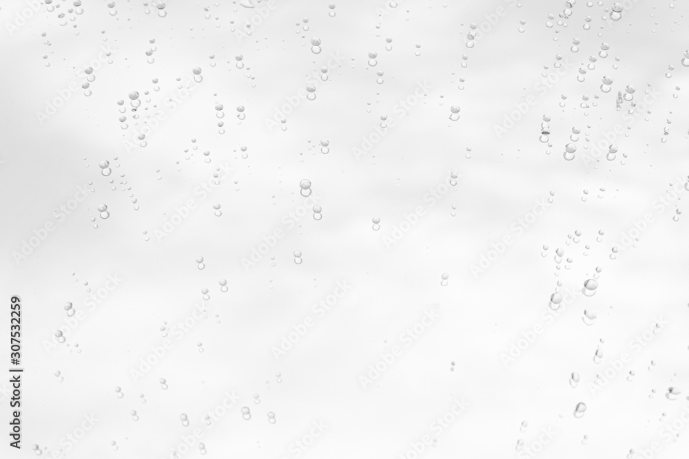 Raindrop water dew drop on glass wet white gray blue background. Raindrop water dew drop on glass wet white gray blue background.