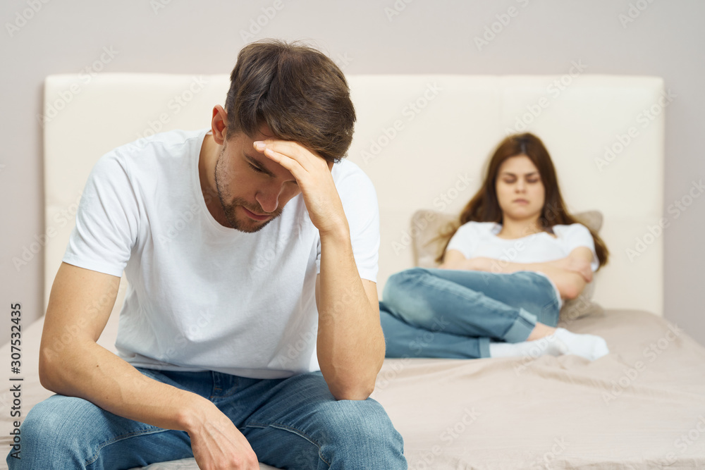 young couple sitting on sofa and watching tv