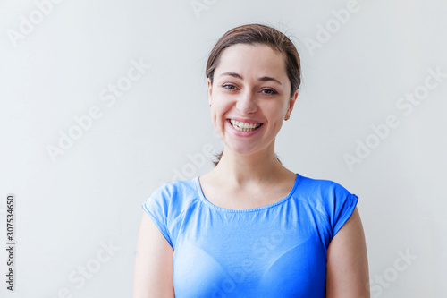 Beauty portrait young happy positive smiling woman, T-shirt colored in trendy color of year 2020 Classic Blue on white background isolated. Bright Macro using color 19-4052 photo