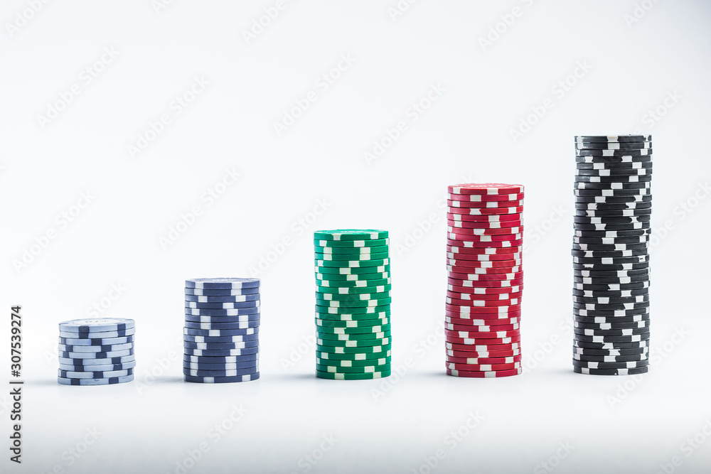 Poker chips on a white background different stacks Poker chips on a white background different stacks