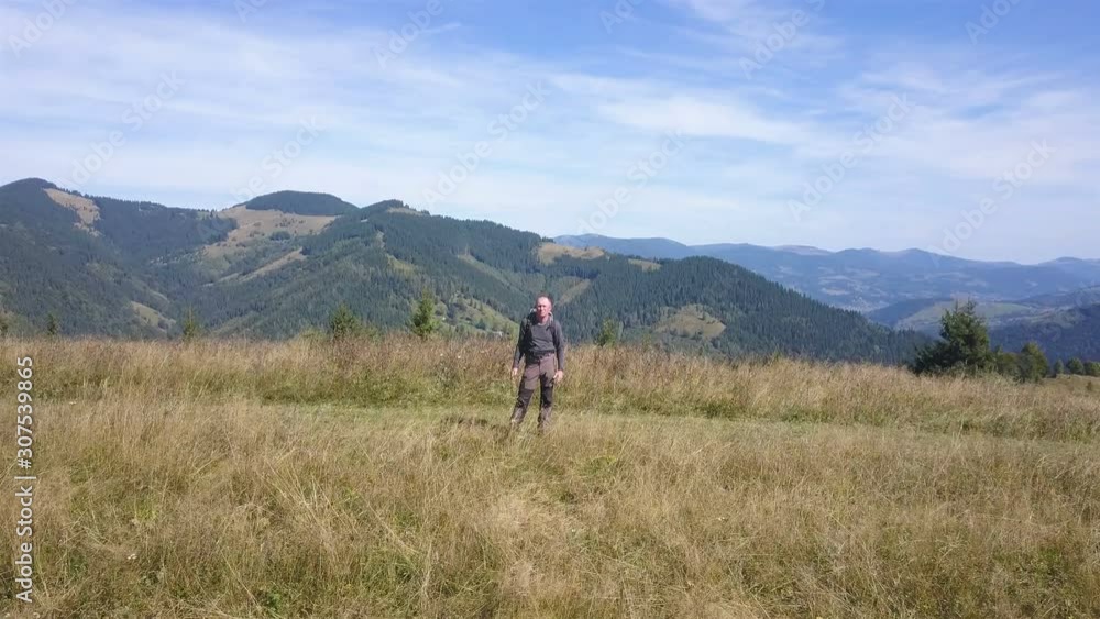 4K .Aerial travel team. Adult man tourist stand on ridge in mountain area. 4K .Aerial travel team. Adult man tourist stand on ridge in mountain area.