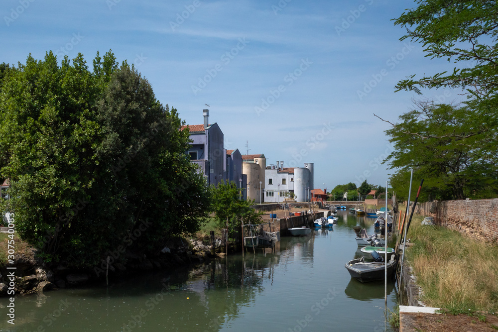 River with boats and buildings on island of Mazzorbo, by Burano, Venice, Italy