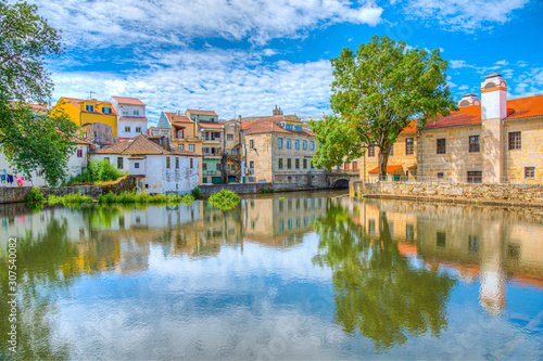 Obraz na płótnie Old buildings in Viseu reflected on a local creek, Portugal