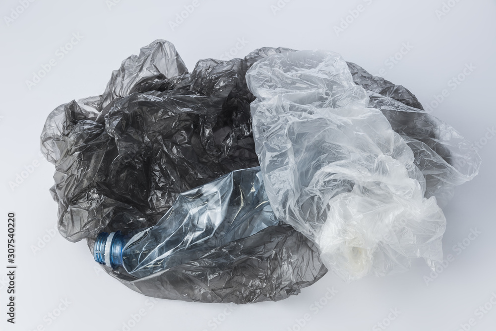 Plastic bags and crumpled bottles on a light background