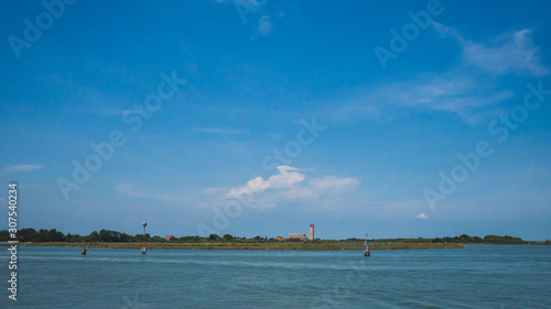View of island of Torcello over water from Burano, Venice, Italy © Mark Zhu