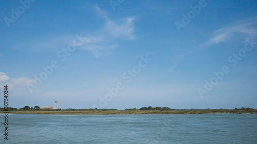 View of island of Torcello over water from Burano, Venice, Italy