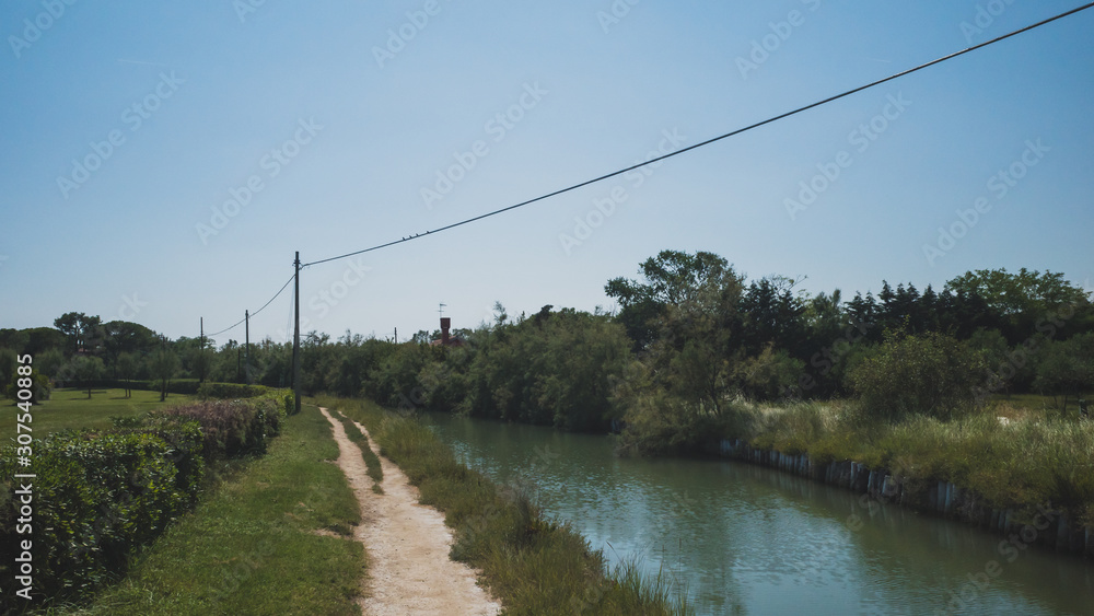 Path by river on island of Torcello, Venice, Italy