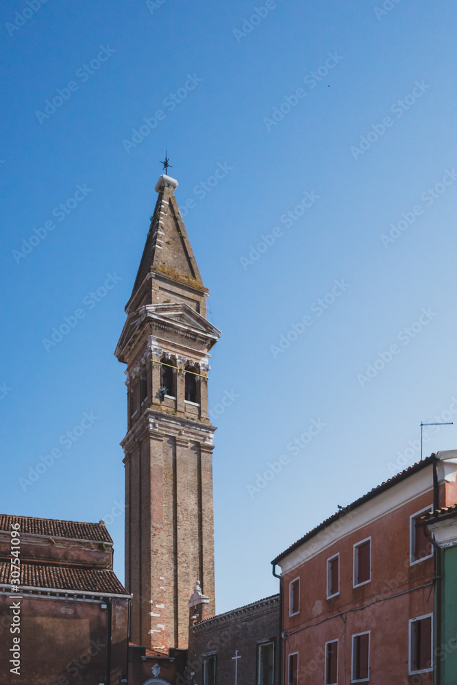 Obraz premium Bell tower over colourful houses on island of Burano, Venice, Italy