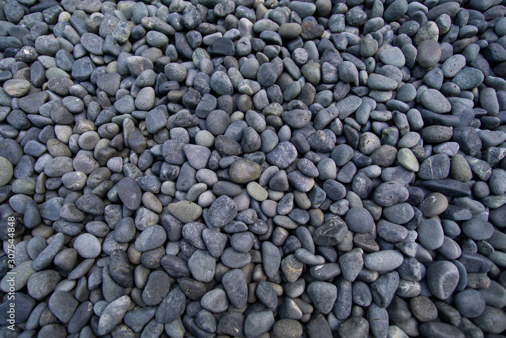 Well-groomed dark gray pebble, small stones. Well-groomed dark gray pebble, small stones.