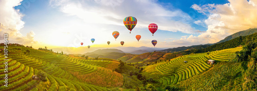 Colorful Hot Air Balloons. Beautiful Sunset scene at Pa Bong Piang terraced rice fields, Mae Chaem, Chiang Mai Thailand photo