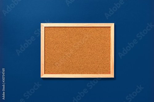 Empty coark board on blue background