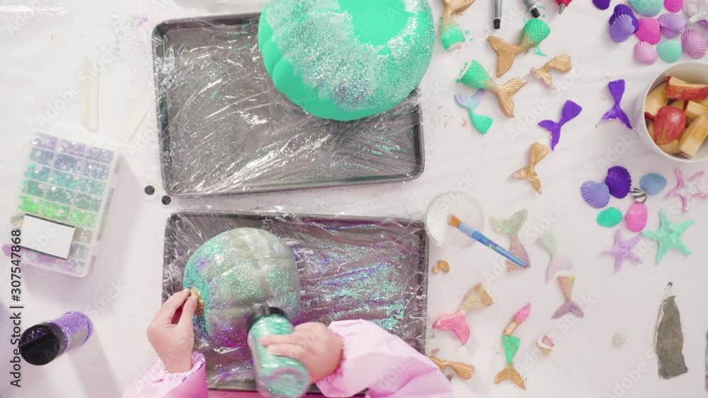 Flat lay. Step by step. Decorating art pumpkins with glitter in mermaid theme for Halloween. Flat lay. Step by step. Decorating art pumpkins with glitter in mermaid theme for Halloween.