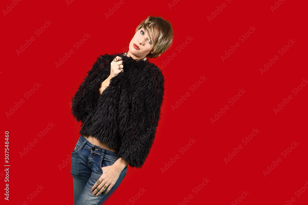 young female model with short hair posing in front of red background young female model with short hair posing in front of red background