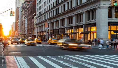 Fotografia, Obraz Crosstown traffic speeding through Midtown Manhattan past the busy crowds of peo