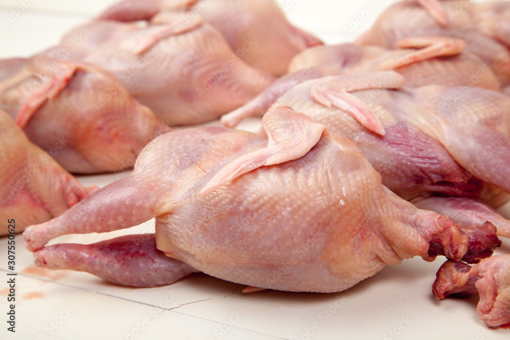 Raw quail meat on a wooden background Raw quail meat on a wooden background