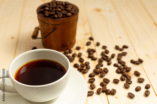 cup of coffee and beans on wooden table