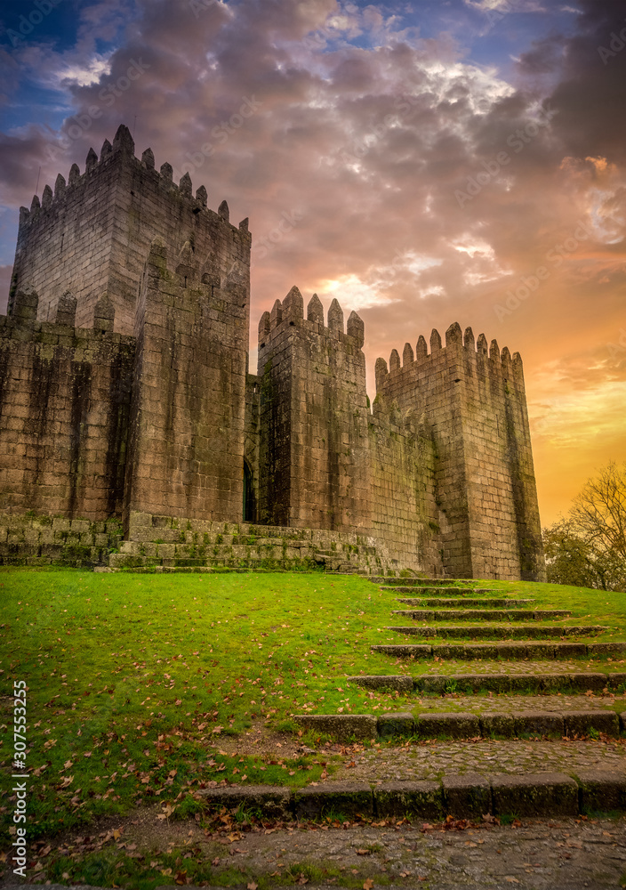Steps leading up to Guimaraes castle with stunning sunset sky