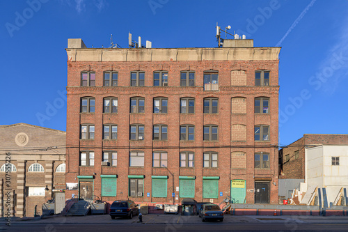 Old-fashioned brickwall factory building against a blue sky on a beautiful sunny day in the Bronx, New York