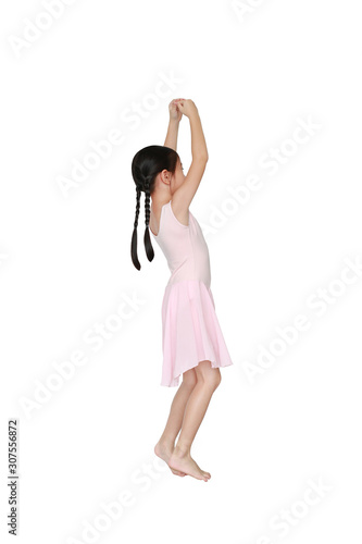 Little Asian child girl ballerina in pink tutu skirt isolated on white background. Kid practise her dance. Children ballet dancer side view.