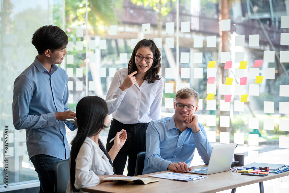 Group of young asian business people together share opinions and propose new marketing and business ideas at meeting. Group of young asian business people together share opinions and propose new marketing and business ideas at meeting.