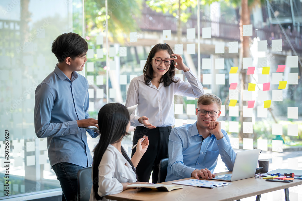 Group of young asian business people together share opinions and propose new marketing and business ideas at meeting. Group of young asian business people together share opinions and propose new marketing and business ideas at meeting.
