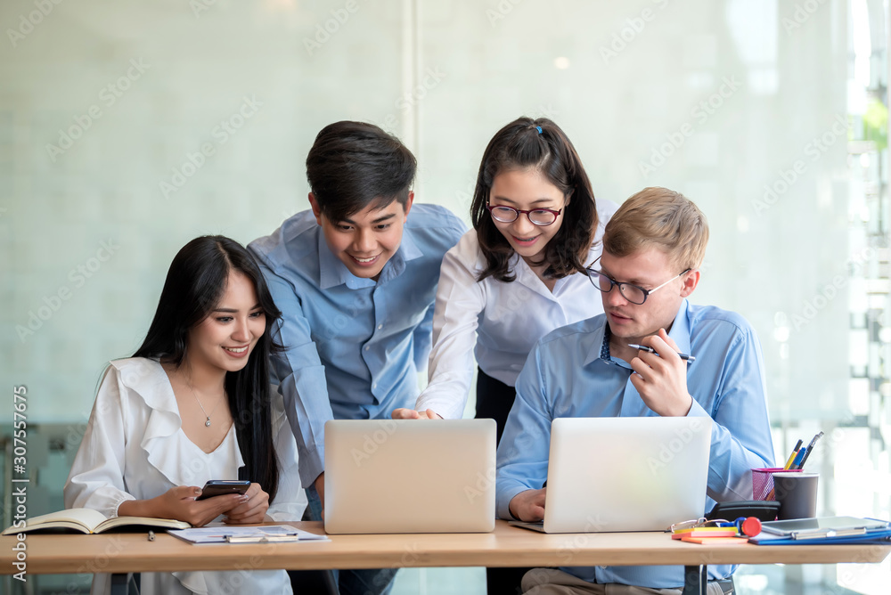 Group of young asian business people together share opinions and propose new marketing and business ideas at meeting.