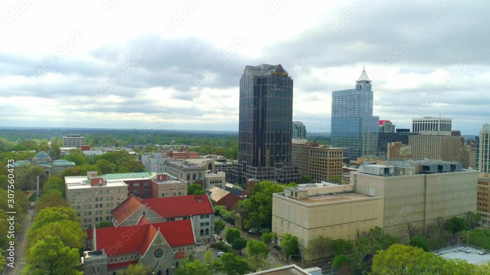 High aerial flight pulling back from downtown Raleigh North Carolina on an overcast day High aerial flight pulling back from downtown Raleigh North Carolina on an overcast day