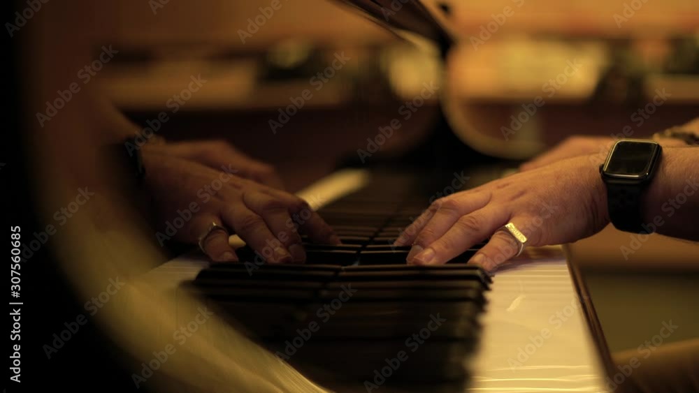 man hands pianist plays gentle classical music on a beautiful grand piano with both hands close-up in slow motion. Student trains to play the piano man hands pianist plays gentle classical music on a beautiful grand piano with both hands close-up in slow motion. Student trains to play the piano