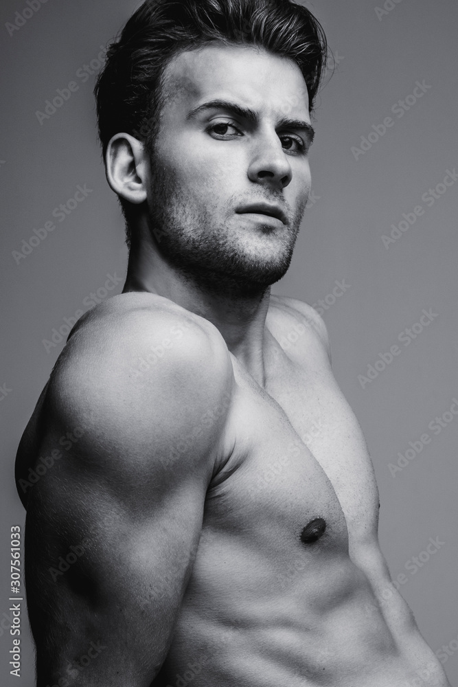 Black and white portrait of handsome young man with stylish haircut. Perfect hair & skin. Close up. Studio shot Black and white portrait of handsome young man with stylish haircut. Perfect hair & skin. Close up. Studio shot