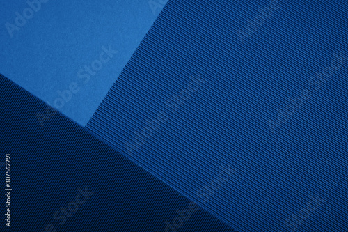Abstract textured geometric paper in blue color background.