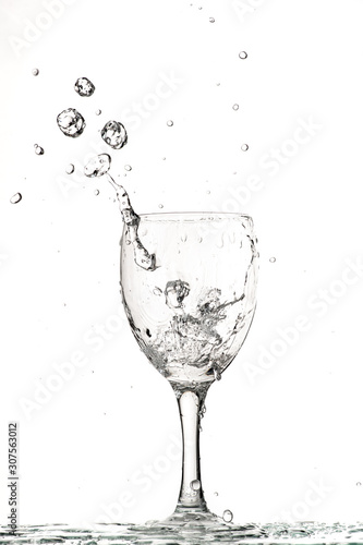 fast flow of wine in a glass, splash and spray black and white