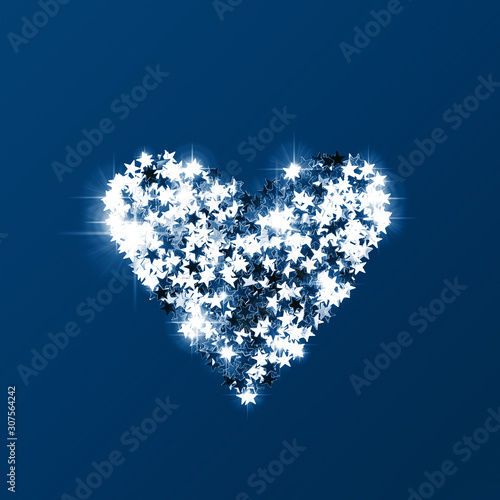 Heart made of silver confetti on trendy blue background. Love concept. Classi...