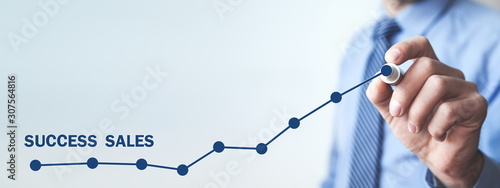 Man with growth graph. Success sales photo