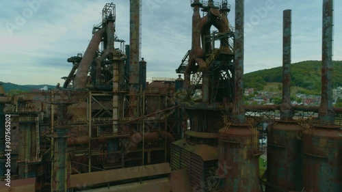 Bethlehem Steel Mill: Close aerial shot flying toward and through the Bethlehem Steel Mill, past greenery and rust photo