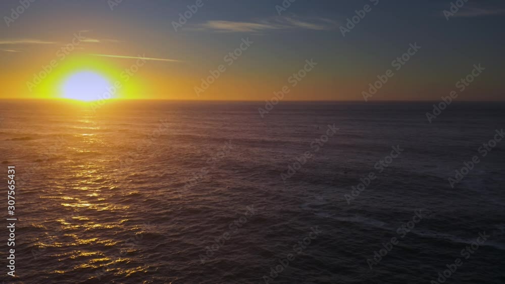 Arcing drone shot of sunset over the sea. Arcing drone shot of sunset over the sea.